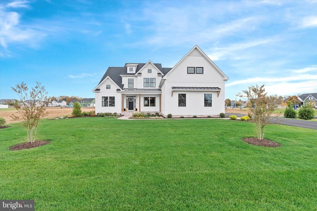 modern farmhouse style home featuring a front lawn