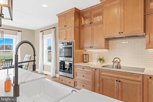 kitchen featuring backsplash, sink, black electric cooktop, and stainless steel double oven