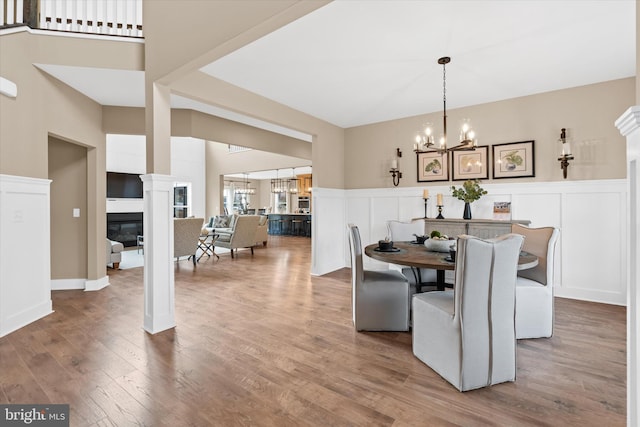 dining area with a chandelier and wood-type flooring