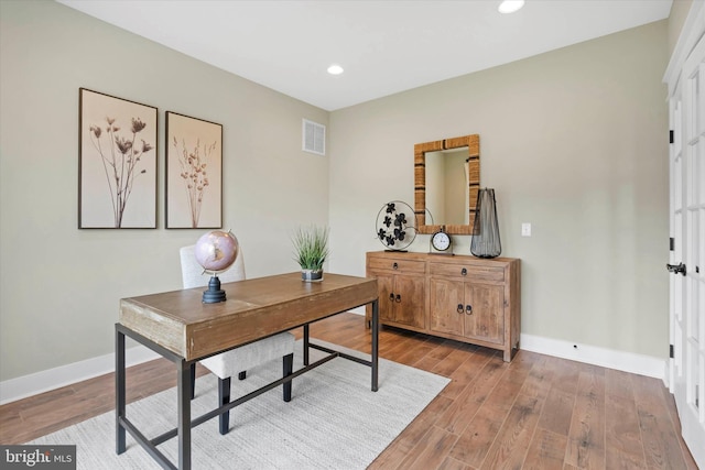 office area with light hardwood / wood-style floors