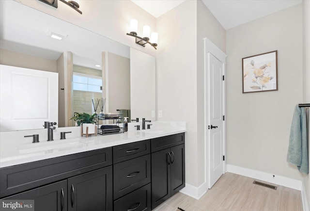 bathroom with vanity and wood-type flooring