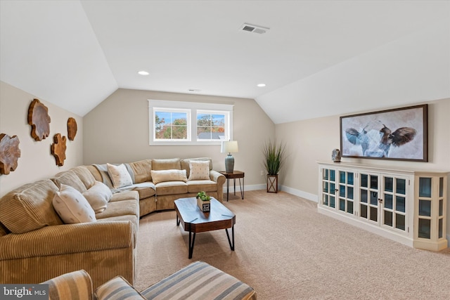 living room with light carpet and vaulted ceiling