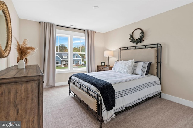 bedroom featuring light carpet