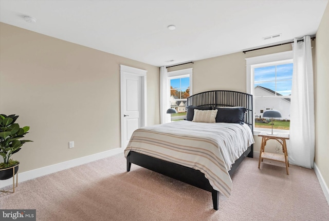 bedroom with light colored carpet