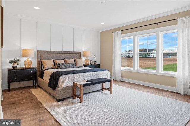 bedroom with crown molding and wood-type flooring