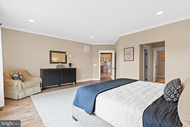 bedroom featuring ornamental molding and light wood-type flooring