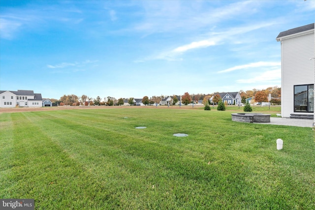 view of yard featuring an outdoor fire pit