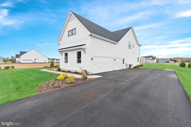 view of property exterior with a garage and a lawn