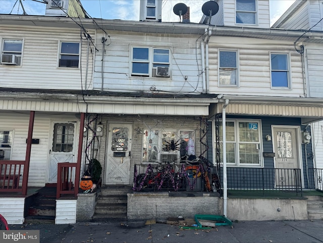 view of property with covered porch and cooling unit