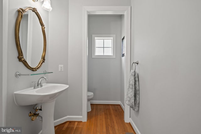 bathroom featuring toilet and wood-type flooring