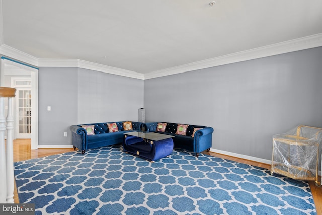 living room featuring hardwood / wood-style floors and crown molding