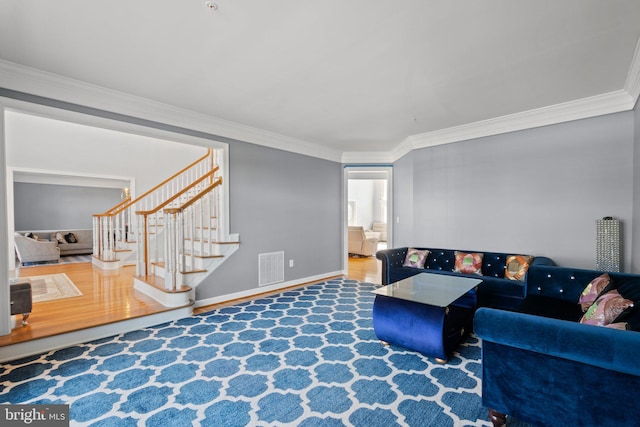 living room with ornamental molding and hardwood / wood-style flooring