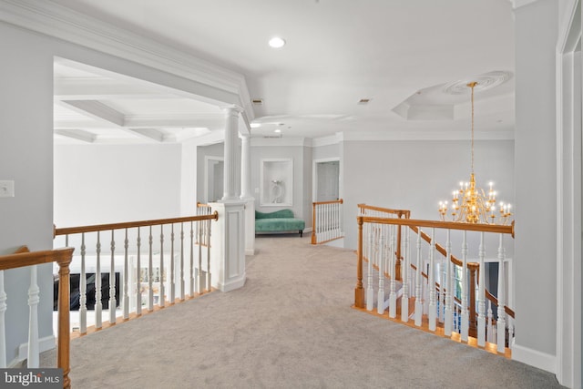 hallway featuring crown molding, a notable chandelier, light carpet, a healthy amount of sunlight, and decorative columns