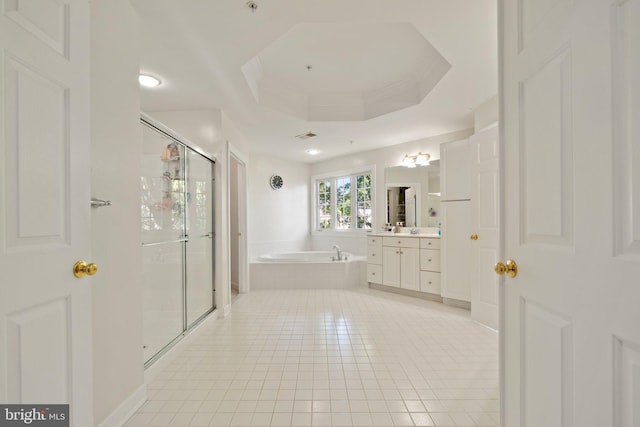 bathroom featuring tile patterned flooring, a tray ceiling, vanity, and independent shower and bath