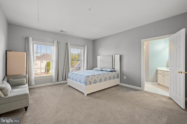 carpeted bedroom featuring connected bathroom