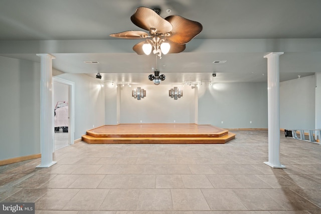 interior space featuring ornate columns, ceiling fan, and light tile patterned floors