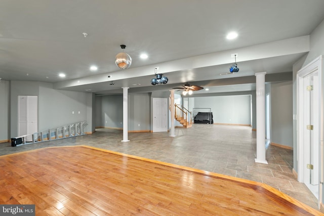 basement featuring ceiling fan and light hardwood / wood-style flooring