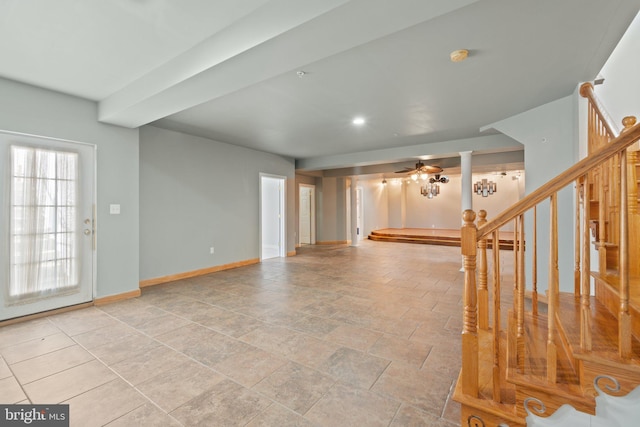 unfurnished living room with ceiling fan and decorative columns