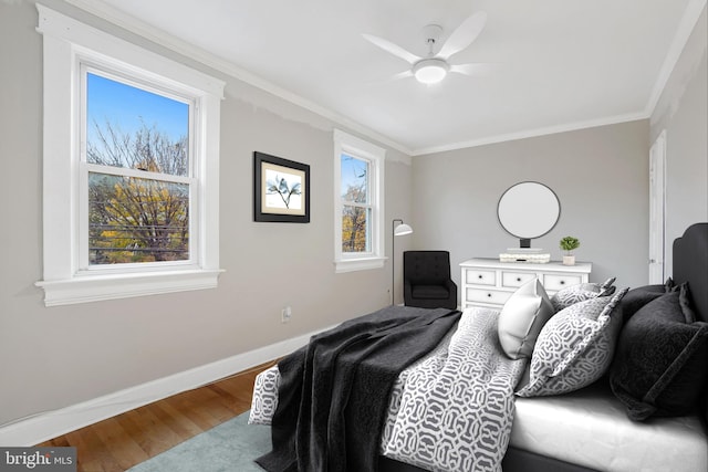 bedroom with hardwood / wood-style flooring, ceiling fan, and multiple windows