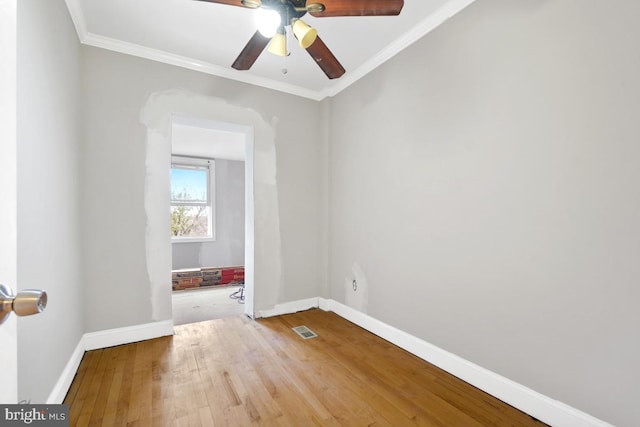 empty room featuring crown molding, ceiling fan, and hardwood / wood-style flooring