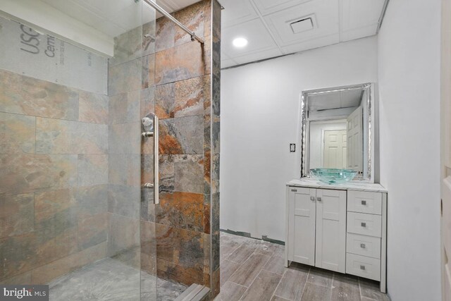 bathroom with vanity and tiled shower