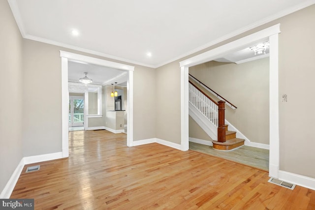 unfurnished living room with crown molding and hardwood / wood-style flooring