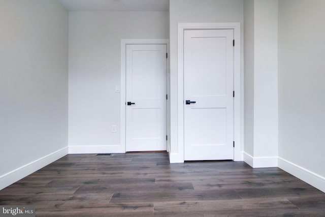 empty room with dark hardwood / wood-style floors