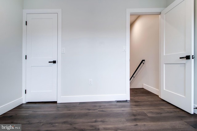 empty room featuring dark wood-type flooring