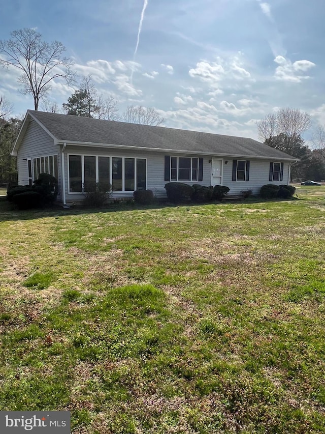 ranch-style house with a sunroom and a front yard