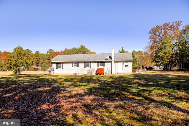 back of property featuring a lawn