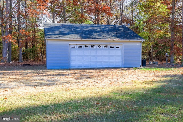 garage featuring a lawn