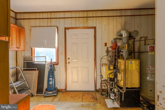 foyer entrance with wood walls and water heater