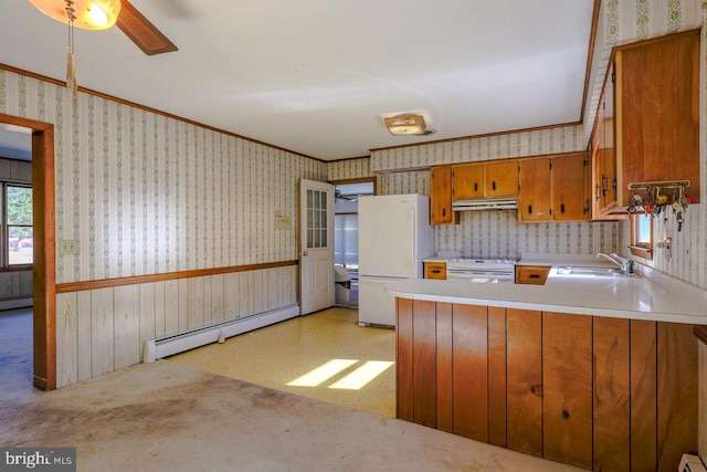 kitchen featuring kitchen peninsula, white appliances, ceiling fan, sink, and a baseboard radiator