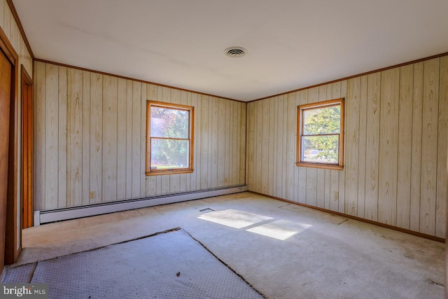 unfurnished room featuring wood walls and a baseboard heating unit