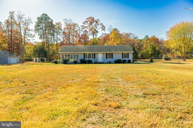 single story home with an outbuilding and a front lawn