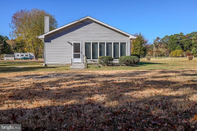 back of property with a lawn