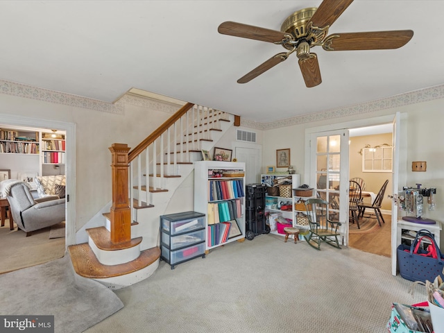 interior space featuring carpet floors and ceiling fan