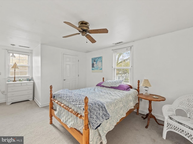 carpeted bedroom with multiple windows and ceiling fan