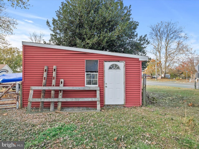 view of outbuilding featuring a yard