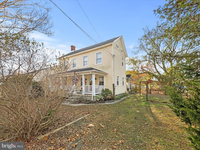 exterior space with a front yard and a porch