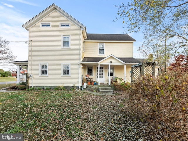 back of property with a porch