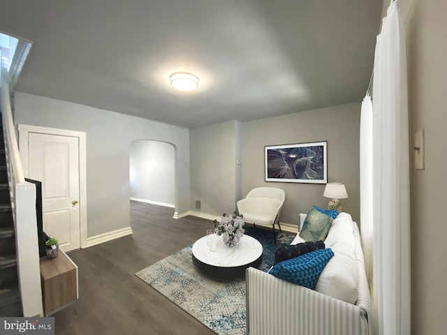 sitting room with dark wood-type flooring