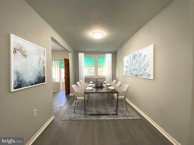 dining area featuring dark wood-type flooring