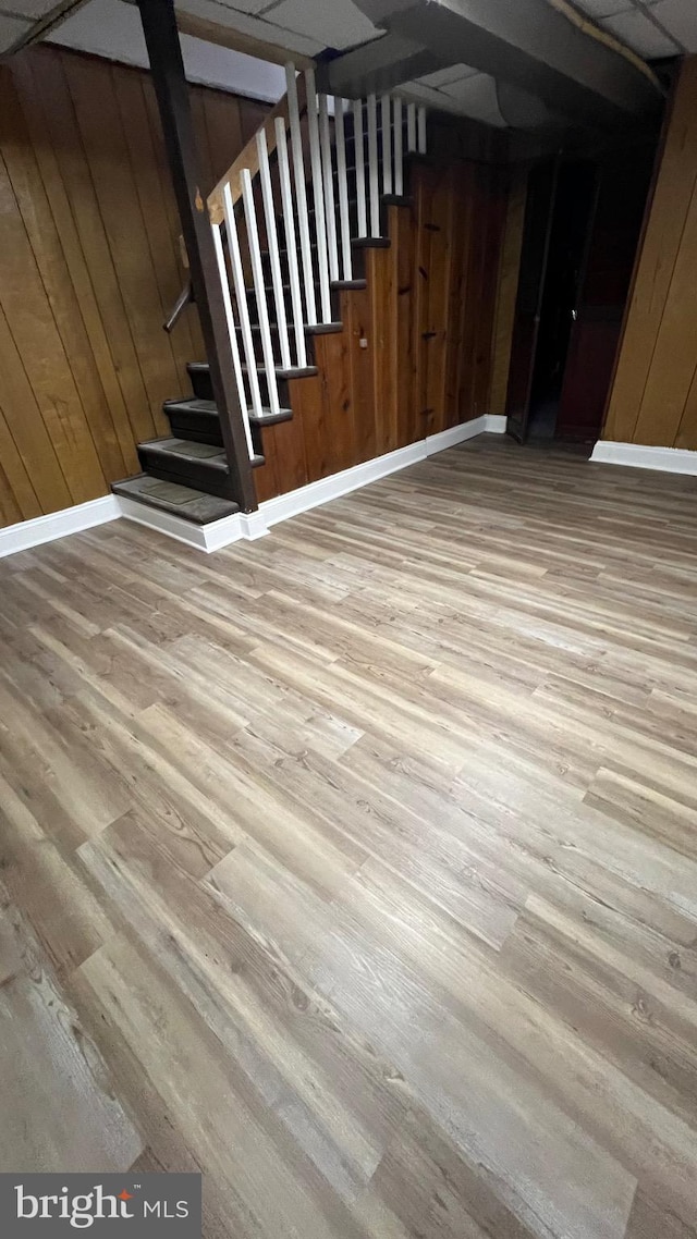 interior space featuring hardwood / wood-style floors and wood walls