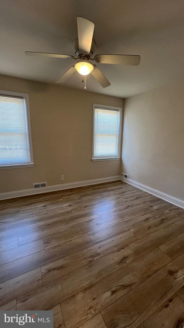 unfurnished room with ceiling fan and hardwood / wood-style flooring