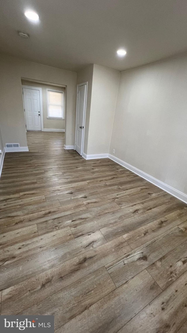 unfurnished room featuring hardwood / wood-style flooring