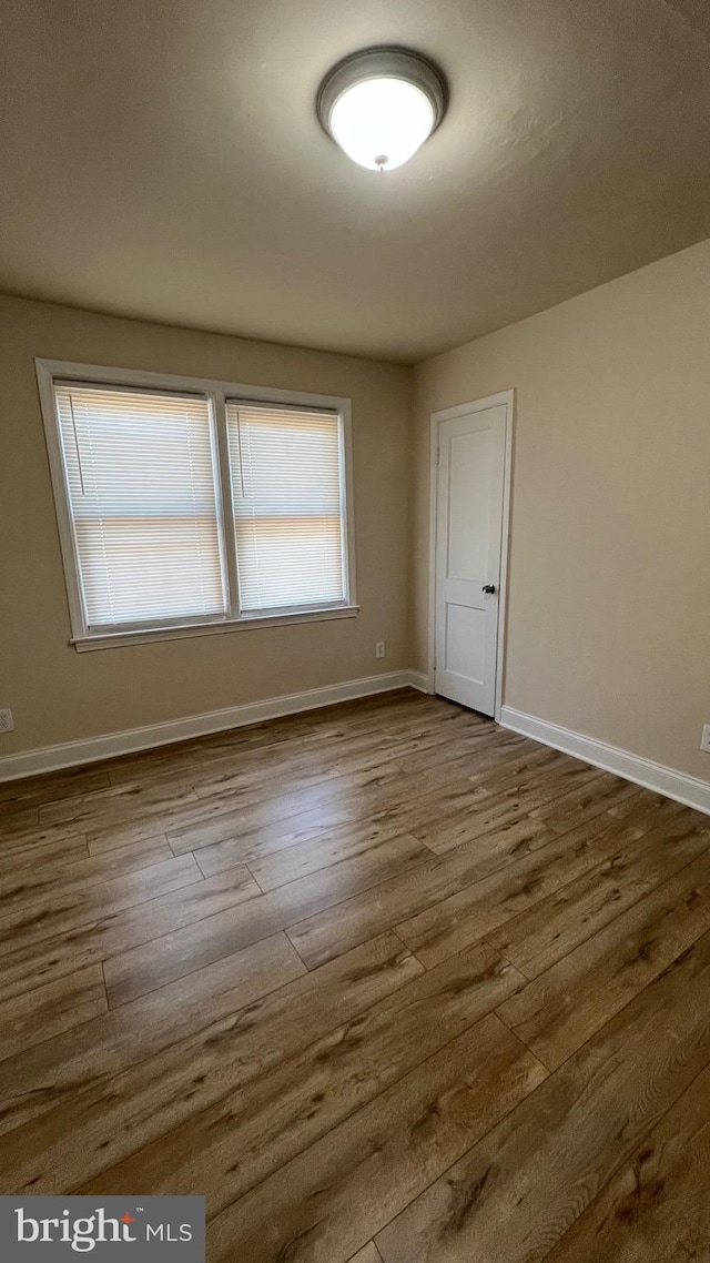 spare room featuring hardwood / wood-style floors