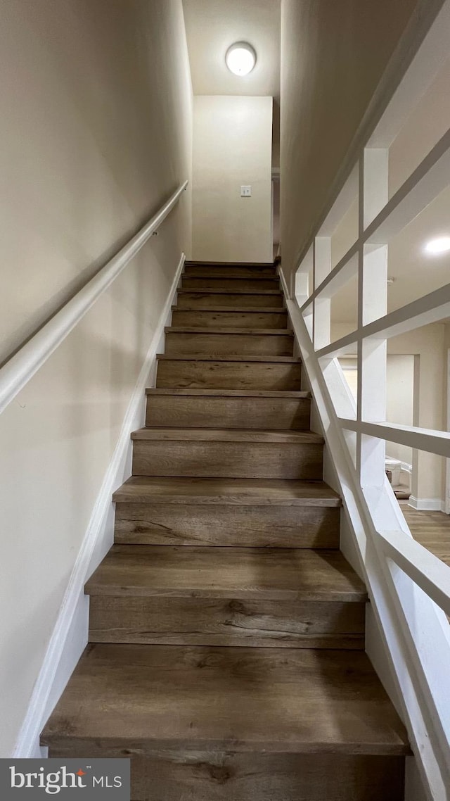 stairs with hardwood / wood-style flooring