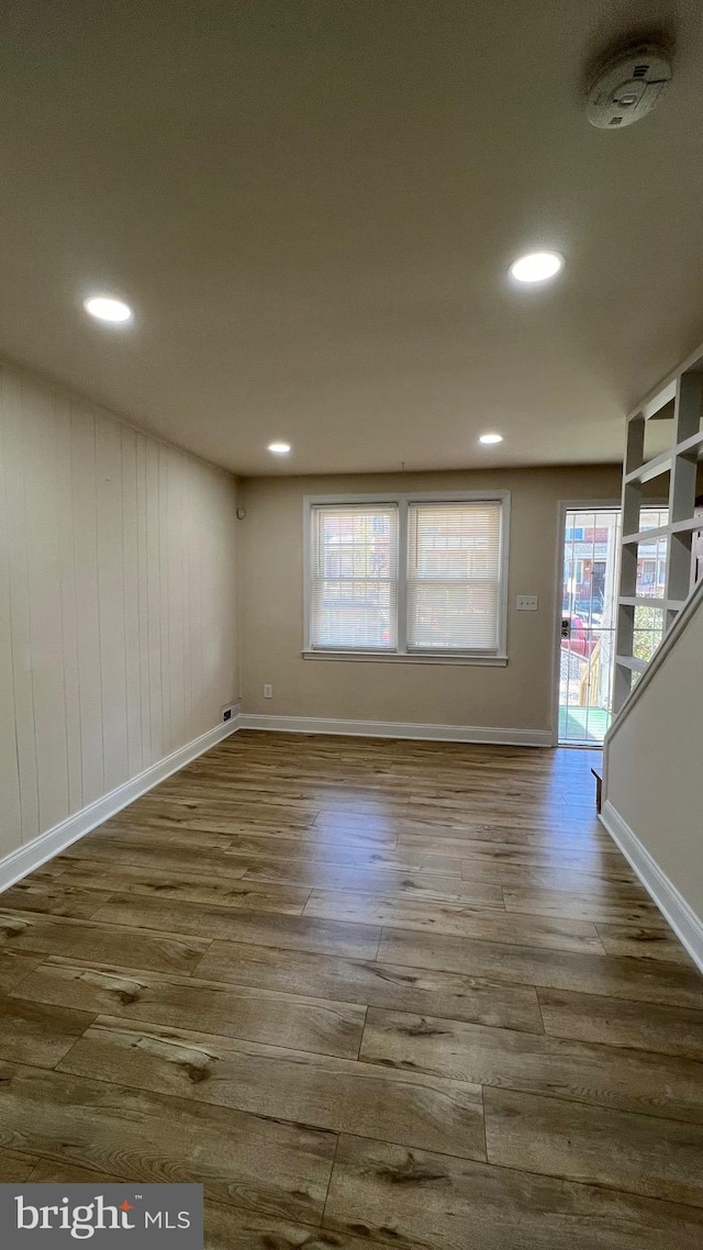 unfurnished room with wood-type flooring and a wealth of natural light