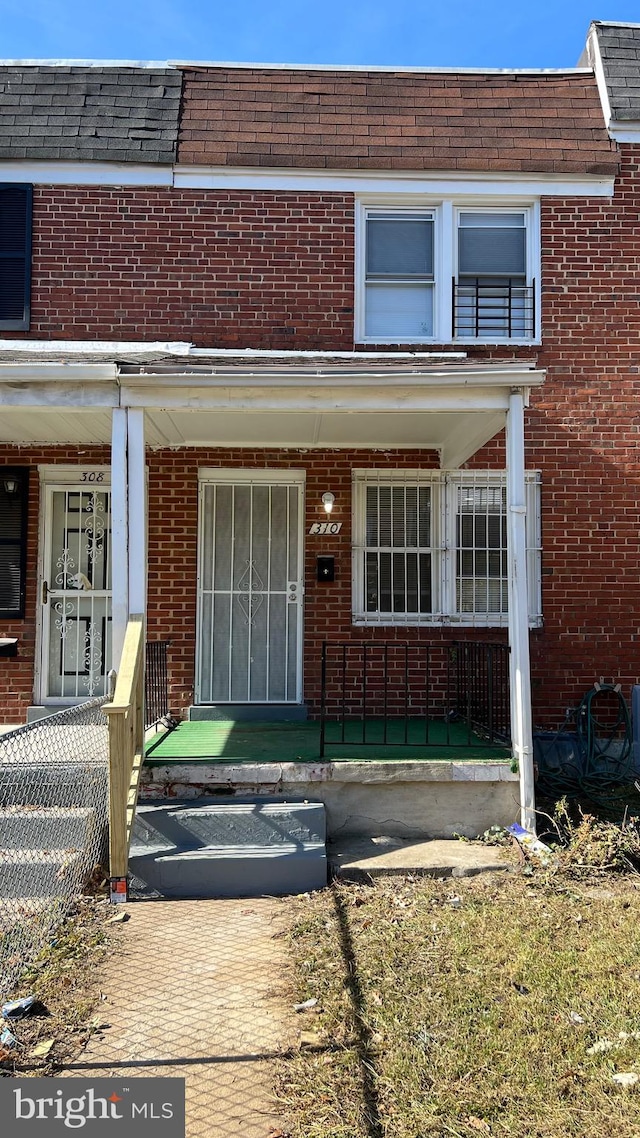 view of exterior entry with covered porch